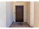 Exterior front door features a secure storm door and welcome mat at 15811 N 155Th Dr, Surprise, AZ 85374
