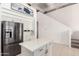 Modern kitchen with white cabinetry, stainless steel appliances, and a center island for food preparation at 15811 N 155Th Dr, Surprise, AZ 85374