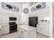 Modern kitchen with white cabinets, stainless steel appliances, and center island, perfect for entertaining at 15811 N 155Th Dr, Surprise, AZ 85374