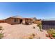 Expansive backyard with a covered patio, gravel landscaping, and a storage shed at 1662 E Kingman Pl, Casa Grande, AZ 85122