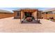 Inviting backyard patio under a pergola, complete with outdoor seating and grill for entertaining at 1662 E Kingman Pl, Casa Grande, AZ 85122