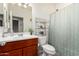 Bathroom featuring a vanity, toilet and shower with a curtain, creating a functional space at 1662 E Kingman Pl, Casa Grande, AZ 85122