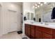 Bright bathroom featuring double sink vanity with dark wood cabinets and ample storage at 1662 E Kingman Pl, Casa Grande, AZ 85122