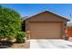 Charming home featuring a two-car garage, low maintenance landscaping, and a cozy, inviting facade at 1662 E Kingman Pl, Casa Grande, AZ 85122