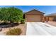 A well maintained house with a 2 car garage, desert landscaping, and concrete driveway at 1662 E Kingman Pl, Casa Grande, AZ 85122