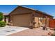 A well maintained house with a 2 car garage, desert landscaping, and concrete driveway at 1662 E Kingman Pl, Casa Grande, AZ 85122
