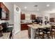 Well-lit kitchen featuring granite countertops, an island with seating, and sleek, modern appliances at 1662 E Kingman Pl, Casa Grande, AZ 85122