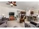 Open concept living room flowing into the kitchen, complete with a ceiling fan and television at 1662 E Kingman Pl, Casa Grande, AZ 85122