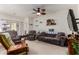 Cozy living room with carpeted floors, ceiling fan, and comfortable furniture, perfect for relaxing at 1662 E Kingman Pl, Casa Grande, AZ 85122