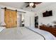 Spacious main bedroom with a wooden sliding barn door to the main bath at 1662 E Kingman Pl, Casa Grande, AZ 85122