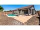 Backyard includes a pool, patio, gravel landscaping, and block wall at 17562 W Gelding Dr, Surprise, AZ 85388