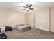 Neutral bedroom featuring a carpeted floor, ceiling fan, and natural light at 17562 W Gelding Dr, Surprise, AZ 85388
