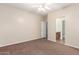 Bedroom with neutral walls, a ceiling fan, and ensuite bathroom at 17562 W Gelding Dr, Surprise, AZ 85388