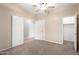 Bright bedroom with neutral walls, ceiling fan, and access to closet and bathroom at 17562 W Gelding Dr, Surprise, AZ 85388