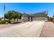 Charming single-story home featuring a two-car garage, desert landscaping and solar panels at 17562 W Gelding Dr, Surprise, AZ 85388