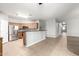 Kitchen featuring stainless steel appliances, ample wood cabinetry, tile flooring, and kitchen peninsula at 17562 W Gelding Dr, Surprise, AZ 85388
