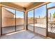 A screened patio with large windows provides a relaxing outdoor space at 17562 W Gelding Dr, Surprise, AZ 85388