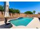 Backyard pool is surrounded by a patio and a block wall at 17562 W Gelding Dr, Surprise, AZ 85388