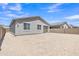 The backyard is spacious, waiting for personalization, showcasing a stucco home and block wall at 1960 N Loretta Pl, Casa Grande, AZ 85122