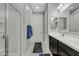Well-lit bathroom with a glass-enclosed shower and sleek vanity with undermount sink, and white tiled floor at 1960 N Loretta Pl, Casa Grande, AZ 85122