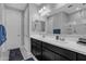 Stylish bathroom featuring dual sinks, modern fixtures, a framed mirror and neutral walls, alongside a separate room at 1960 N Loretta Pl, Casa Grande, AZ 85122