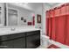 Modern bathroom with vanity, a large mirror, and red shower curtain at 1960 N Loretta Pl, Casa Grande, AZ 85122
