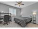 Cozy bedroom with plush carpeting, ceiling fan, and a window letting in natural light, complete with desk at 1960 N Loretta Pl, Casa Grande, AZ 85122
