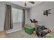Bedroom with window, ceiling fan, packed boxes, and a gray interior at 1960 N Loretta Pl, Casa Grande, AZ 85122