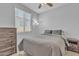 Cozy bedroom with neutral tones, window, ceiling fan and wood furnishings at 1960 N Loretta Pl, Casa Grande, AZ 85122