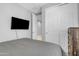 Bedroom showcases mounted TV, closet, and neutral tones for a modern feel at 1960 N Loretta Pl, Casa Grande, AZ 85122