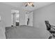 Spacious bedroom with ceiling fan, access to bathroom and closet, and a comfortable bed with gray bedding at 1960 N Loretta Pl, Casa Grande, AZ 85122