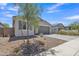 View of a modern stucco house with a gray garage door and well maintained desert landscaping at 1960 N Loretta Pl, Casa Grande, AZ 85122