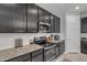 Modern kitchen features granite counters, stainless steel appliances, white subway tile backsplash, and sleek dark cabinetry at 1960 N Loretta Pl, Casa Grande, AZ 85122