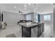 Open concept kitchen featuring granite island with seating, stainless steel dishwasher, and view of living room at 1960 N Loretta Pl, Casa Grande, AZ 85122