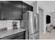 Kitchen with stainless steel appliances, granite countertops, sleek dark cabinets, and a tiled backsplash at 1960 N Loretta Pl, Casa Grande, AZ 85122