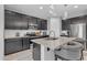 This modern kitchen has granite countertops, stainless steel appliances, a large island, and stylish pendant lighting at 1960 N Loretta Pl, Casa Grande, AZ 85122