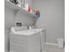 Clean laundry room featuring a white washer, dryer, shelves, and tile floor at 1960 N Loretta Pl, Casa Grande, AZ 85122