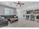 Open-concept living room with tile flooring, ceiling fan, comfortable seating, and view of the kitchen at 1960 N Loretta Pl, Casa Grande, AZ 85122