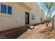 Backyard view featuring a stucco wall, stone groundcover, and multiple windows at 2000 N 36Th St # 14, Phoenix, AZ 85008