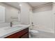 Modern bathroom with a white quartz countertop, wood vanity, and a shower-tub combination at 2000 N 36Th St # 14, Phoenix, AZ 85008