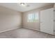 Bright bedroom features neutral walls, plush carpeting, and a window providing natural light at 2000 N 36Th St # 14, Phoenix, AZ 85008