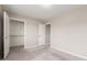 A carpeted bedroom features a closet, an additional doorway, and neutral colored walls at 2000 N 36Th St # 14, Phoenix, AZ 85008