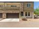 Modern townhome showcasing stone accents, private balcony, and a single-car garage at 2000 N 36Th St # 14, Phoenix, AZ 85008