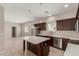 A modern kitchen showcasing an island, stainless appliances, ample counter space, and dark cabinets at 2000 N 36Th St # 14, Phoenix, AZ 85008