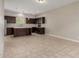 Open-concept kitchen with dark wood cabinetry, an island, and stainless steel appliances at 2000 N 36Th St # 14, Phoenix, AZ 85008