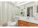 Clean bathroom featuring a vanity with wooden cabinetry, a toilet, and a shower with curtain at 2020 W Union Hills Dr # 156, Phoenix, AZ 85027
