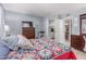 Inviting bedroom with a dresser and a bed with a colorful quilt, closet is partially visible at 2020 W Union Hills Dr # 156, Phoenix, AZ 85027