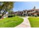 Well-maintained community grounds featuring lush green grass, paved walkways, and outdoor grills at 2020 W Union Hills Dr # 156, Phoenix, AZ 85027