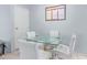 Bright dining area with a modern glass table and white chairs at 2020 W Union Hills Dr # 156, Phoenix, AZ 85027