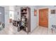 Inviting entryway with tile floors, decorative mirror, wooden door, and storage bookshelf at 2020 W Union Hills Dr # 156, Phoenix, AZ 85027